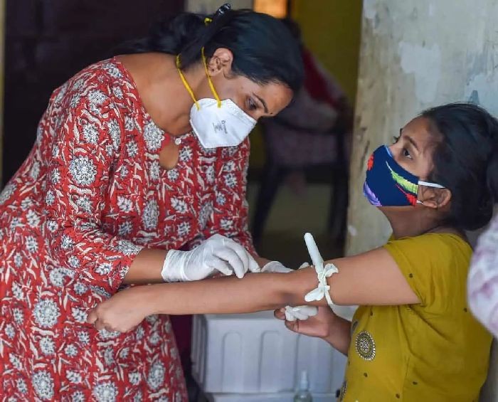 New Delhi: A health worker collects a blood sample of a woman for a serological survey at an Anganwadi Center, in New Delhi, Thursday, Sept. 3, 2020. (PTI Photo/Manvender Vashist)
